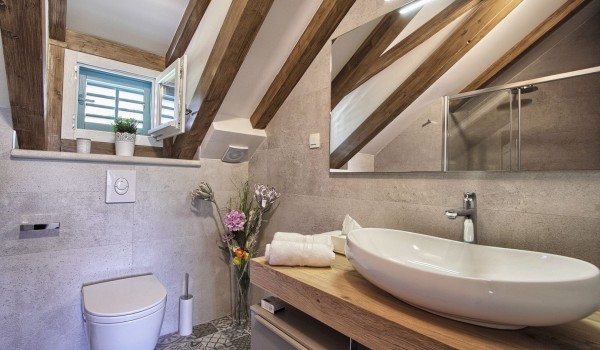Luxurious bathroom in the attic of the historic stone villa near the sea Cavtat Iliria for a family rent and vacation near Dubrovnik