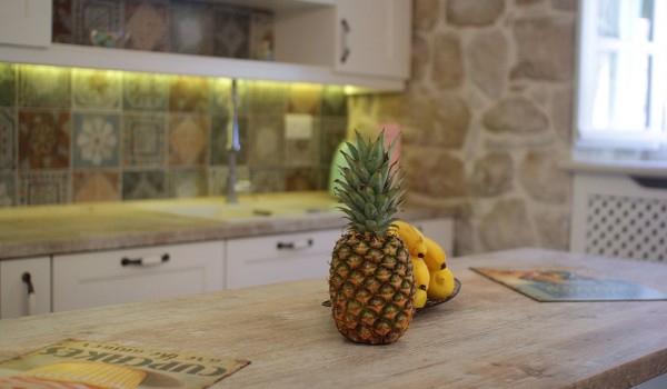 Beautiful wooden table in the dining and kitchen area on the ground floor of the private exclusive villa Cavtat Iliria with private parking