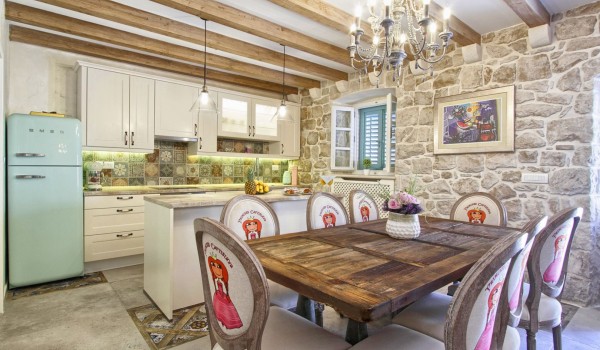 Spacious air-conditioned dining area and a fully equipped kitchen on the ground floor of a private Dubrovnik rental for 8 with a jacuzzi
