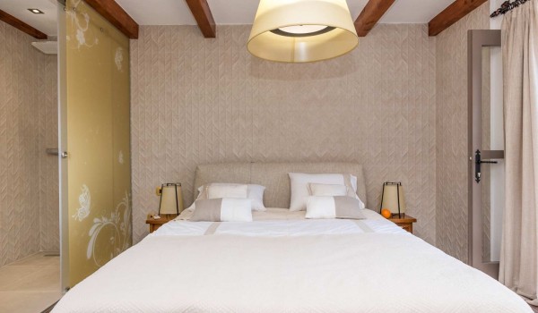 King size bed in a bedroom of a luxury pet-friendly villa for family vacation in Skradin
