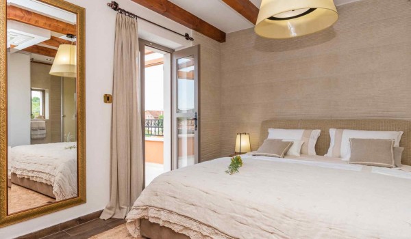 King size bed in a bedroom with direct entrance to the terrace of a luxury pet-friendly villa for vacation with friends in Skradin