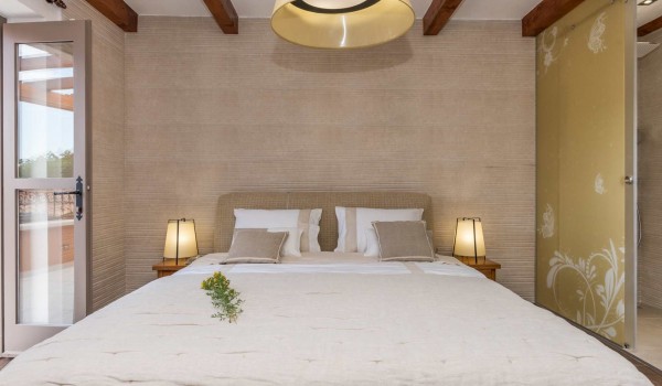 King size bed in a bedroom with direct entrance to the terrace of a luxury pet-friendly villa for vacation with friends in Skradin