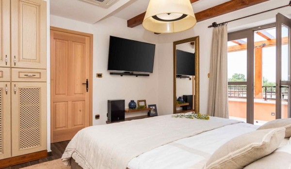 King size bed in a bedroom with direct entrance to the terrace of a luxury pet-friendly villa for vacation with friends in Skradin