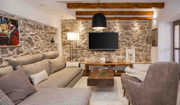 Comfortable sofas and TV in a living room of a luxury pet-friendly villa for vacation with friends in Skradin