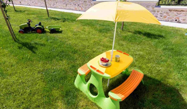 Plastic outdoor set for children in the garden of a luxury Croatian villa for family vacation in Skradin