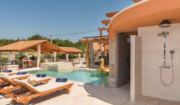 Outdoor shower and deck chairs on the terrace of a luxury family villa for vacation in Skradin with complete privacy