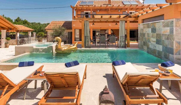 Deck chairs by the heated pool of a luxury Croatian villa with concierge service and parking with complete privacy