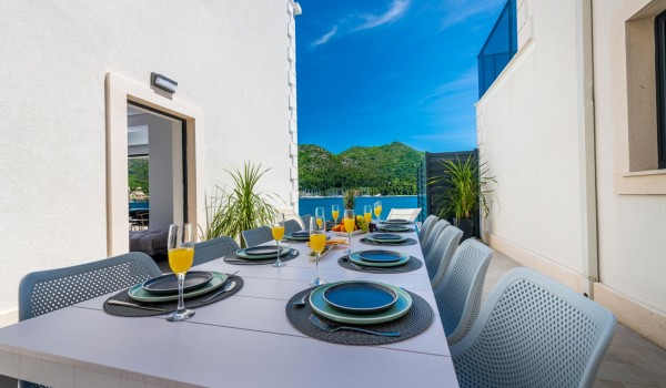 Outdoor dining table on the terrace of Croatia luxury pool villa with sea view for vacation and rent
