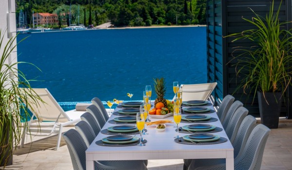 Outdoor dining table of Croatia luxury pool villa with sea view for family vacation in Dubrovnik