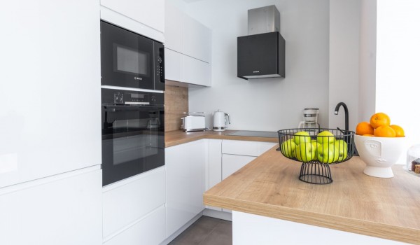 Fully equipped kitchen area of the luxury pool villa Zaira with microwave and stove for rent with family