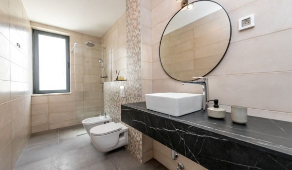 Luxury bathroom of Croatia luxury family villa with shower cabin and sink with mirror for vacation and rent