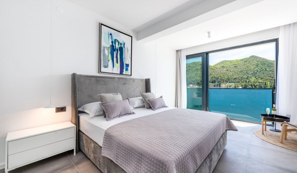 Bedroom of Croatia luxury pool villa with king-size bed and private balcony with sea view for rent