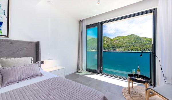 Bedroom of the luxury holiday villa Zaira Dubrovnik with king-size bed and sea view window for rent