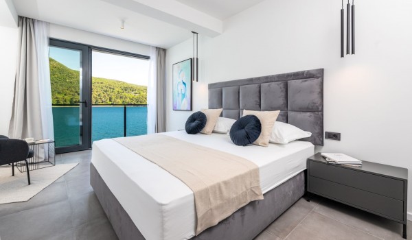 Master bedroom of Croatia luxury private villa with king-size bed and balcony with sea view for rent