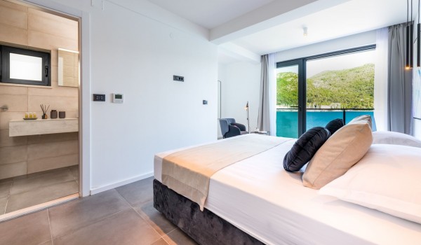 Master bedroom of Croatia luxury family villa with king-size bed and private bathroom for vacation and rent