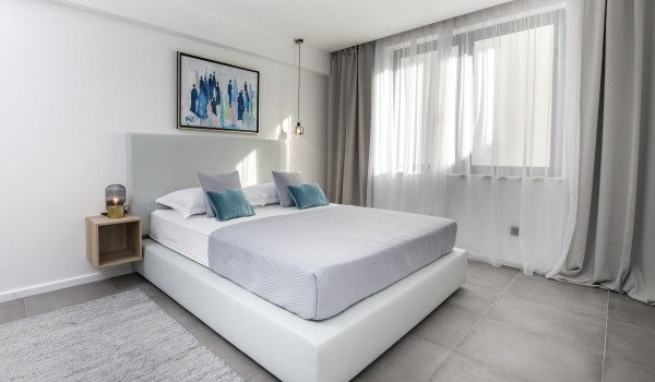 Bedroom of Croatia luxury pool villa with king-size bed and night stand with lamp for family vacation