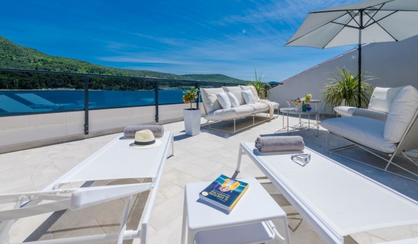 Private balcony of Croatia luxury pool villa with deckchairs and sundeck for vacation and rent with friends