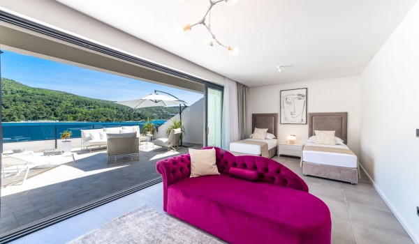 Bedroom of Croatia luxury pool villa with two single beds and lounge area for vacation and rent with family