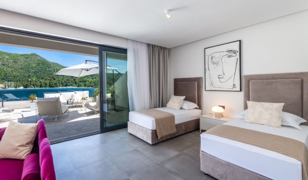 Bedroom of Croatia luxury sea view villa with two single beds and lounge area for vacation and rent with friends