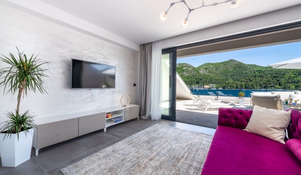 Bedroom of the luxury pool villa Zaira with SMART TV and sofa for relaxing with friends and family in Dubrovnik
