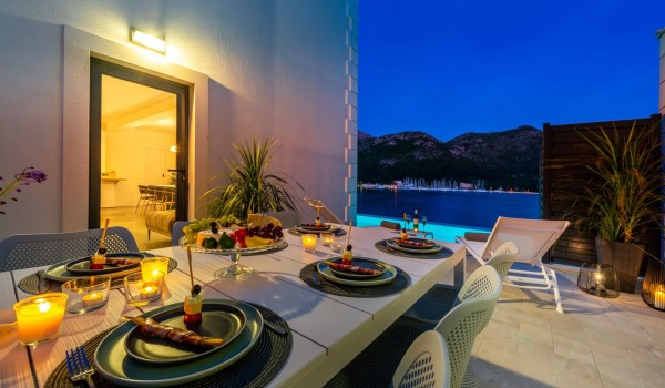 Outdoor dining table on the terrace of Croatia luxury pool villa with sea view for vacation and rent