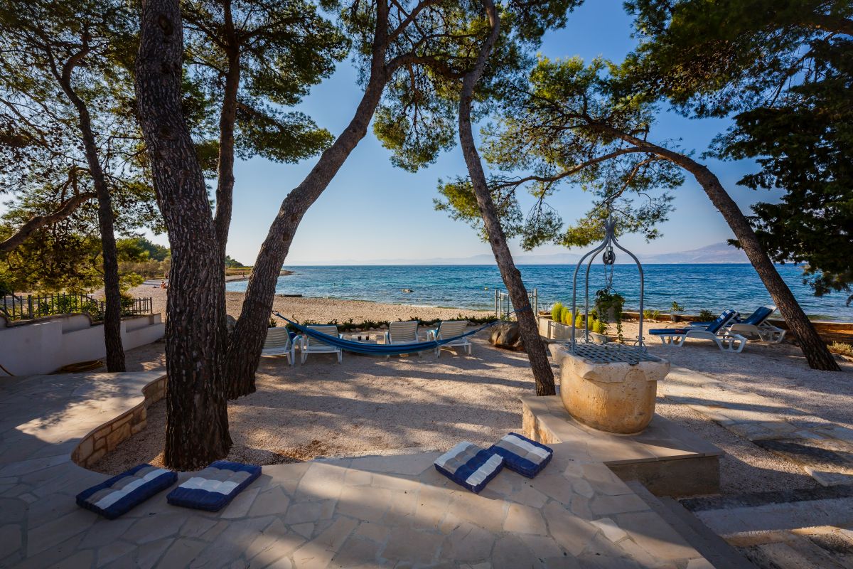Seating area and deck chairs in front of the Croatian luxury vacation house Summer Retreat on Brac island