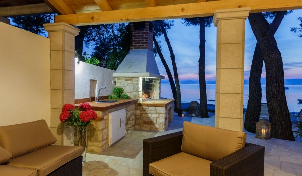 Seating area in the shade on the terrace of the Croatia beachfront house for vacation with friends on Brac island