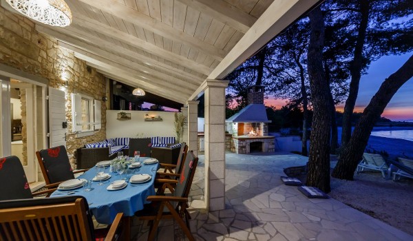 Outdoor dining table on the terrace of the Brac stone house with beach view