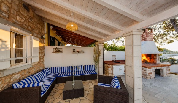 Seating area on the terrace of the Brac family house Summer Retreat on the beach