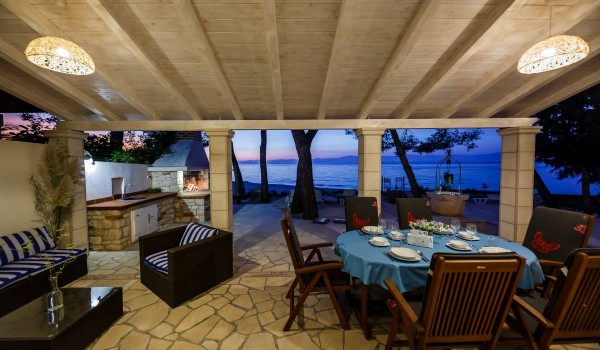 Outdoor dining table on the terrace of the Brac stone house with beach view