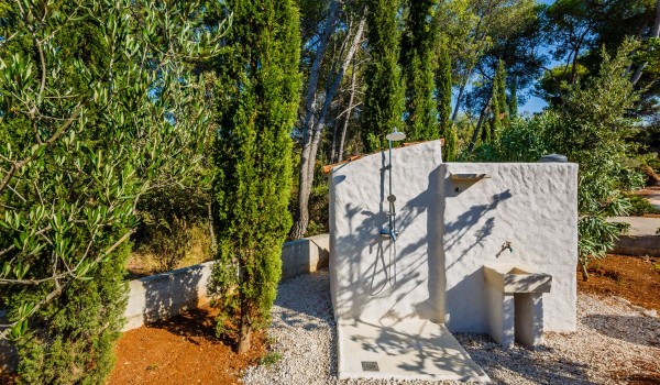 Stone outdoor shower in the courtyard of the Brac family vacation house by the sea