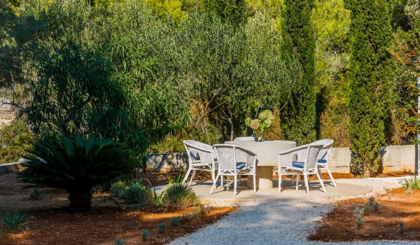 Seating area in the landscaped garden of the traditional stone villa at the beach on Brac island