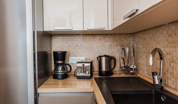 Coffee maker, toaster and kettle in a charming kitchen of the beachfront family vacation house on Brac island