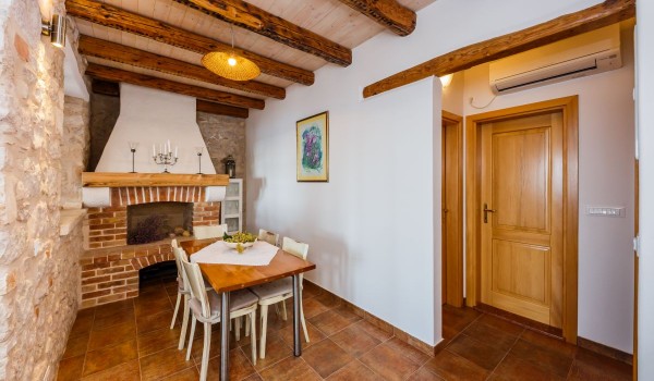 Dining area and inside grill in the traditional stone house Summer Retreat with private parking