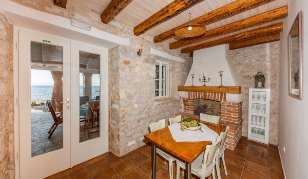 Dining area and inside grill in the traditional stone house Summer Retreat with private parking