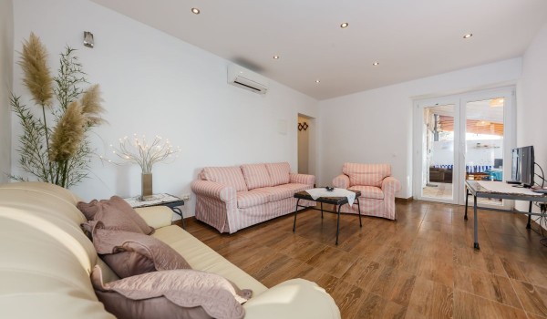 Charming living room with comfortable sofas in the beachfront family villa on Brac island with private parking
