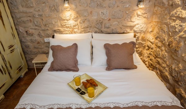 Breakfast in bed in a traditional stone house at the beach on Brac island