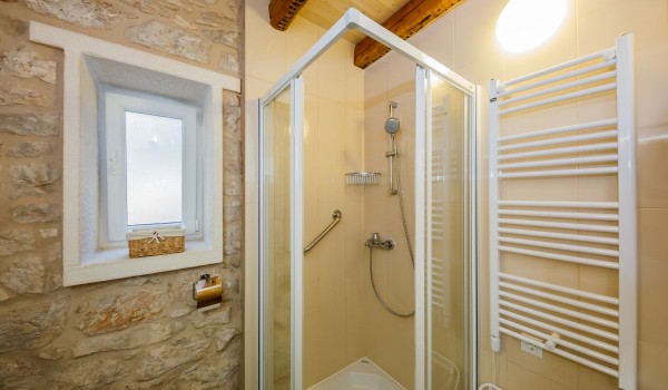 Shower in a bathroom of a traditional beachfront house for family vacation by the sea