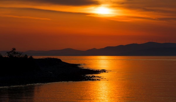 Mesmerizing sunset in front of a traditional beachfront stone villa on Brac island