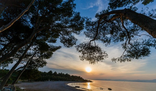 Mesmerizing sunset in front of a traditional beachfront stone villa on Brac island