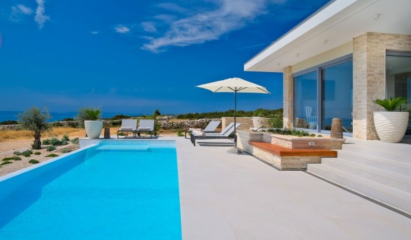 View of the sea from the private heated pool of the luxurious modern villa Summer Dream Privacy Novalja for rent and vacation with family on the island of Pag with concierge service on reques