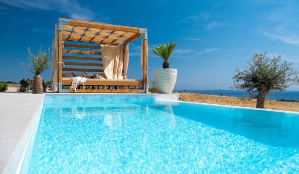 Private swimming pool with sundeck of the luxurious Croatian air-conditioned villa Summer Dream Privacy Novalja with a view of the sea and the beach