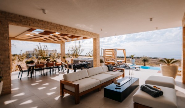 Outdoor living space with dining table, lounge furniture and barbecue of modern air-conditioned villas with swimming pool Summer Dream Privacy Novalja for rent and peaceful vacation by the se