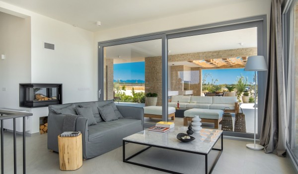 Air-conditioned seating area with sofa and armchair and access to the lounge terrace with outdoor kitchen and barbecue of the luxury holiday villa by the sea Summer Dream Privacy Novalja