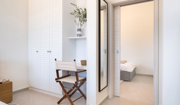 A family bedroom connected by sliding doors to a single bedroom in a modern family villa for rent by the sea with a private heated pool on the island of Pag