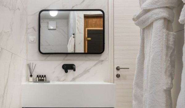 Washbasin with mirror and robes in the en-suite bathroom of the luxury Croatian villa for rent Summer Dream Privacy Novalja on the island of Pag