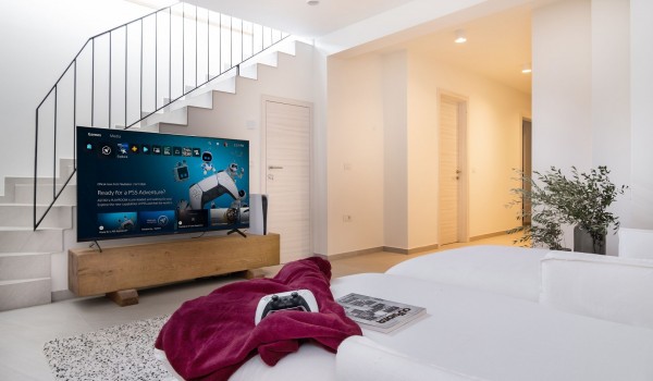 A spacious air-conditioned game room with lounge sofas for relaxing, board games and a PS5 console in a villa for rent with a swimming pool and a sauna Summer Dream Privacy Novalja on the isl
