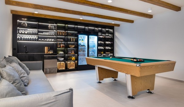 Elegant air-conditioned space with a pool table and a private bar for pleasant gatherings in a modern Croatian villa for rent with a swimming pool on the island of Pag for 7 people