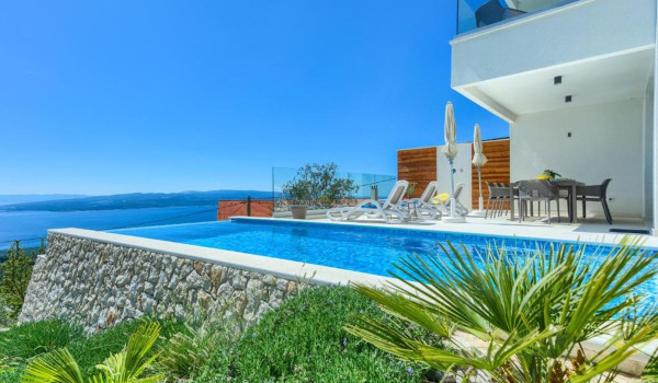 View of the outdoor heated pool on the outdoor terrace of the Croatian luxury villa for vacation and rental White Diamond
