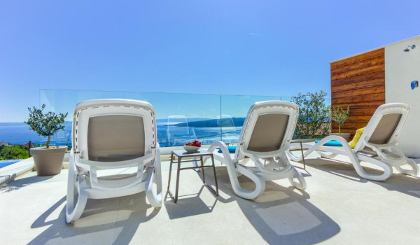 Comfortable deckchairs by the private pool on the property of the Croatian luxury villa for rent White Diamond
